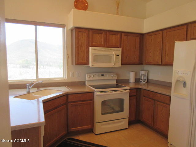 1881 Via Ochoa Rio Rico, AZ 85648 - Photo 27 of 44 a kitchen with a sink stove and cabinets
