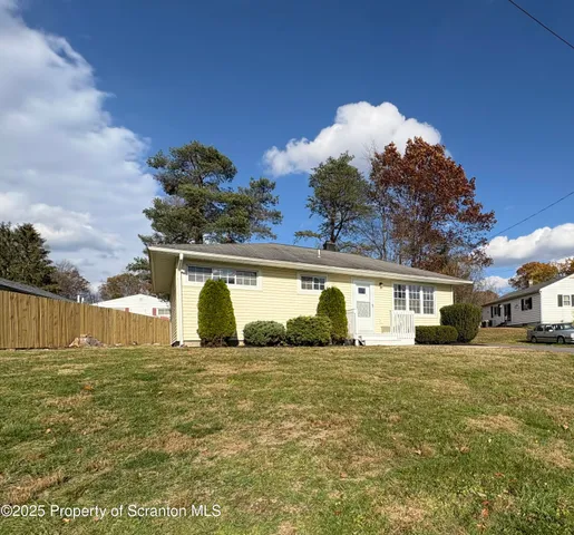 a view of a house with a yard