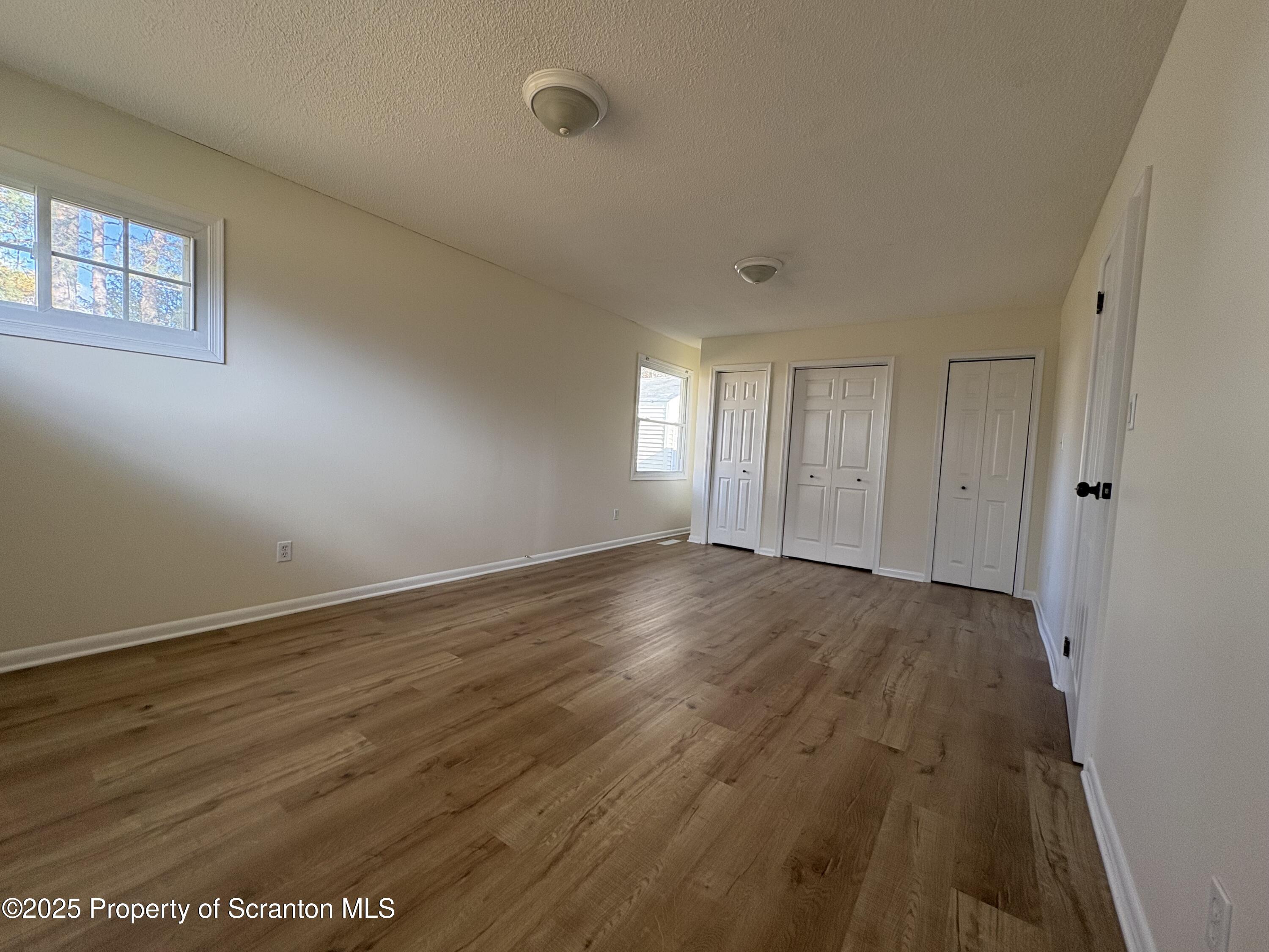 812 Old Winola Road Clarks Summit, PA 18411 - Photo 21 of 25 a view of an empty room with wooden floor and a window