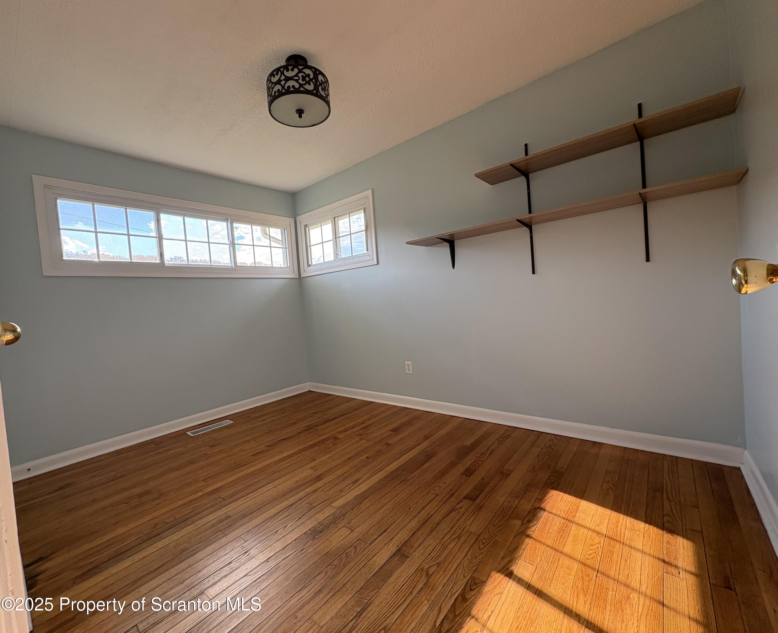 812 Old Winola Road Clarks Summit, PA 18411 - Photo 24 of 25 a view of room with window and wooden floor