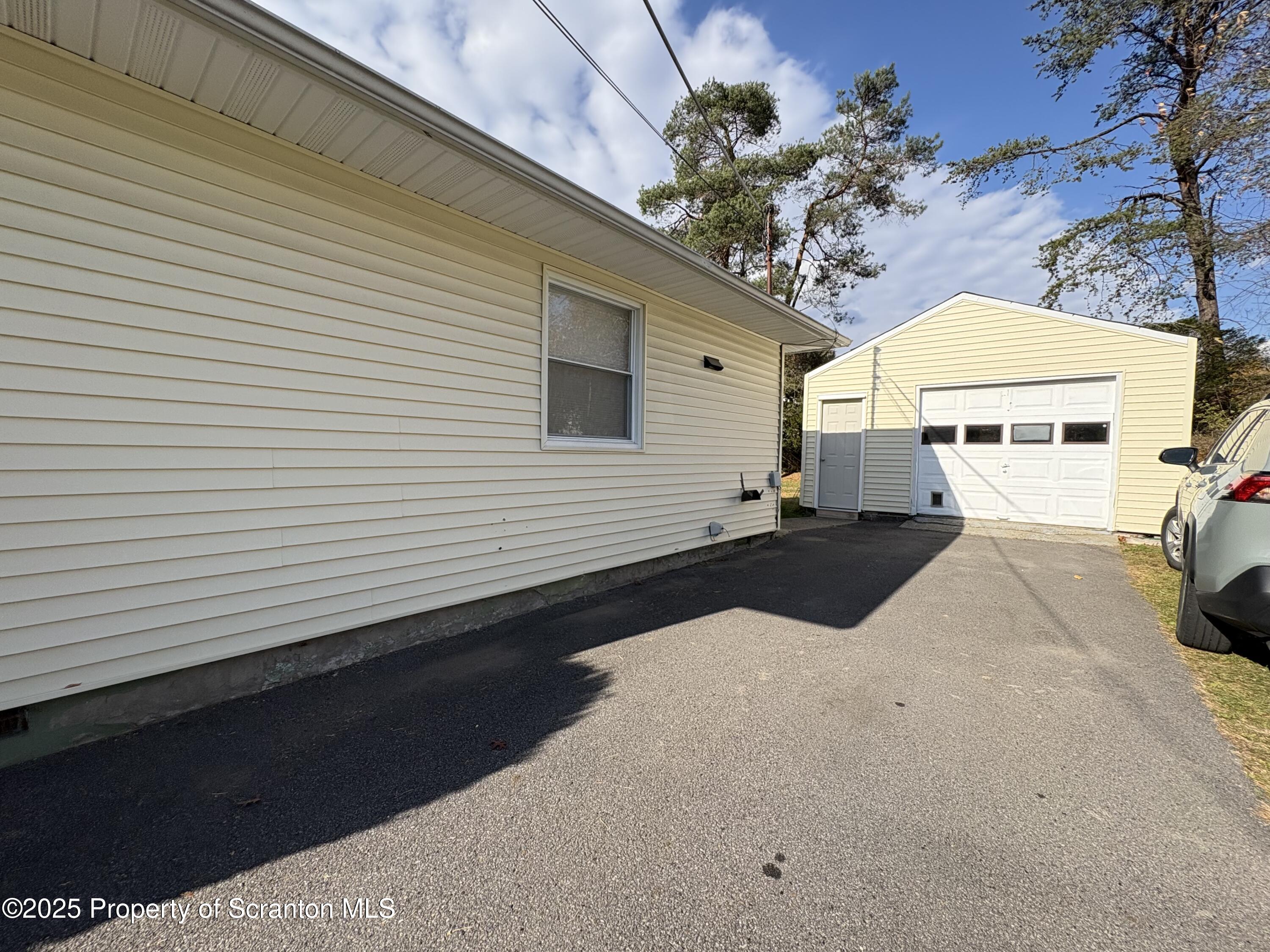 812 Old Winola Road Clarks Summit, PA 18411 - Photo 4 of 25 a potted plant sitting in front of a house