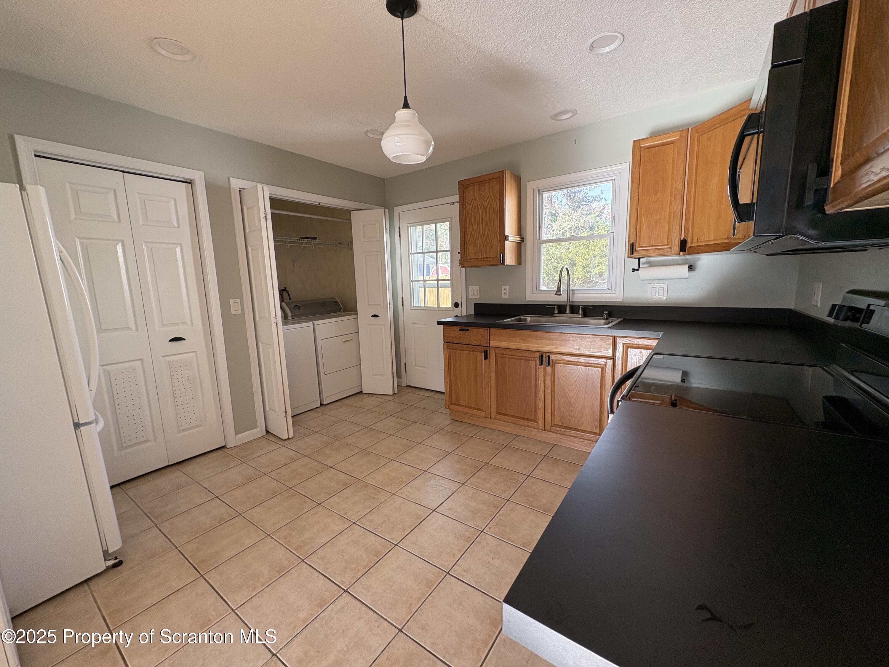 812 Old Winola Road Clarks Summit, PA 18411 - Photo 10 of 25 a kitchen with stainless steel appliances granite countertop a stove a sink and a refrigerator