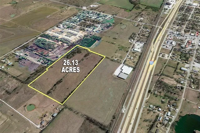 an aerial view of a residential apartment building with a yard