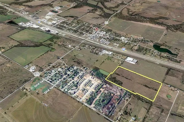 an aerial view of a residential apartment building with a yard