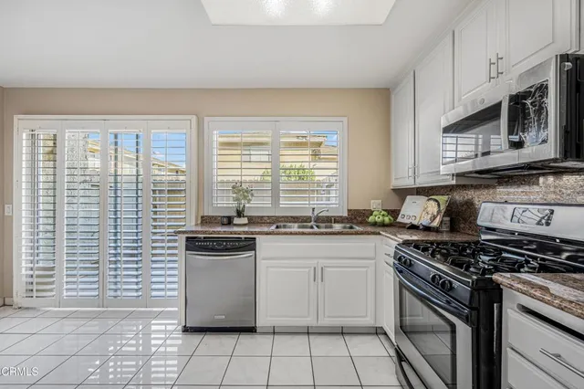a kitchen with a stove a sink and a microwave
