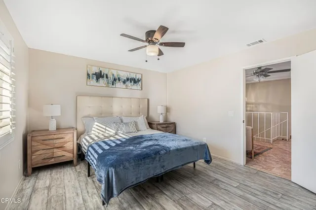 a bedroom with a bed and a view of kitchen
