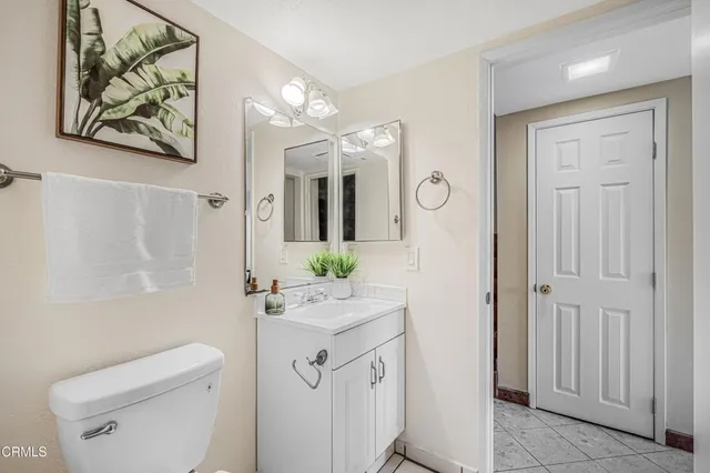 a bathroom with a sink vanity mirror and toilet
