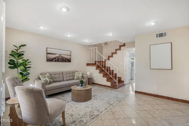 a living room with furniture and a potted plant