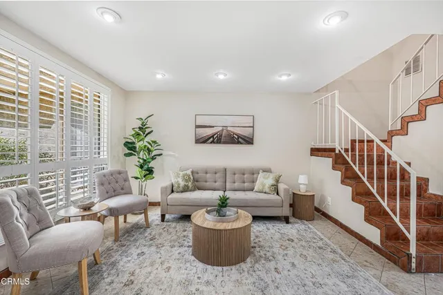 a living room with furniture and a potted plant