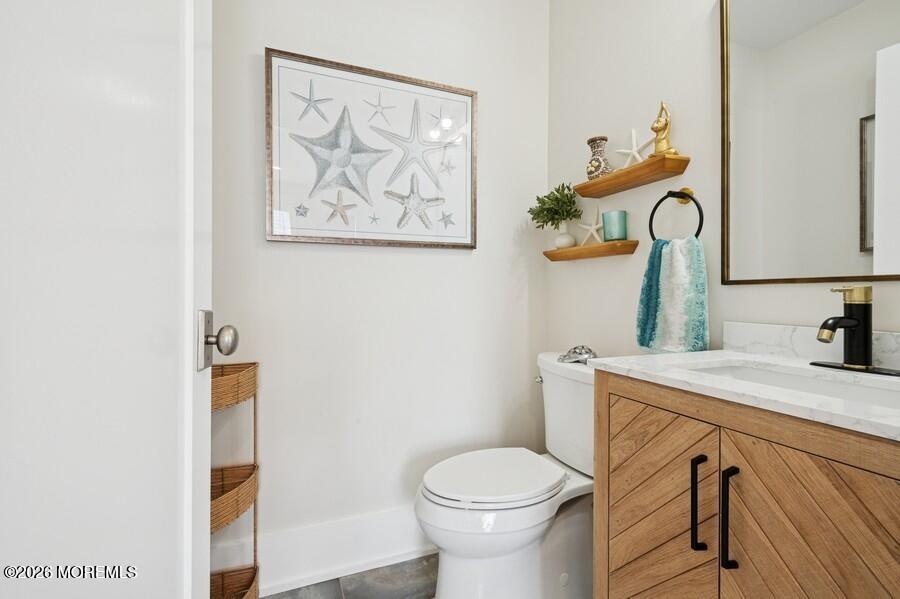 124 2nd Avenue Manasquan, NJ 08736 - Photo 12 of 38 a bathroom with a toilet sink and mirror