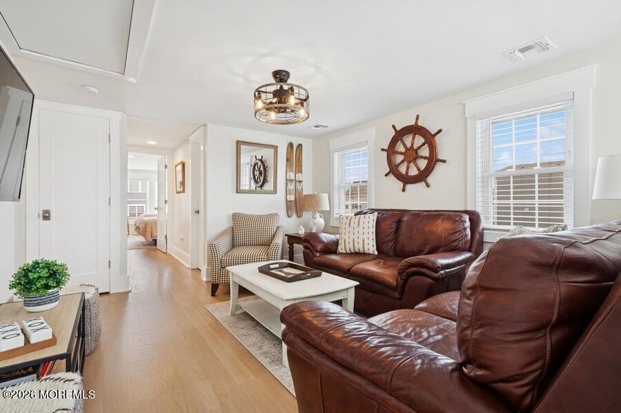 124 2nd Avenue Manasquan, NJ 08736 - Photo 14 of 38 a living room with furniture a couch and paintings on the wall