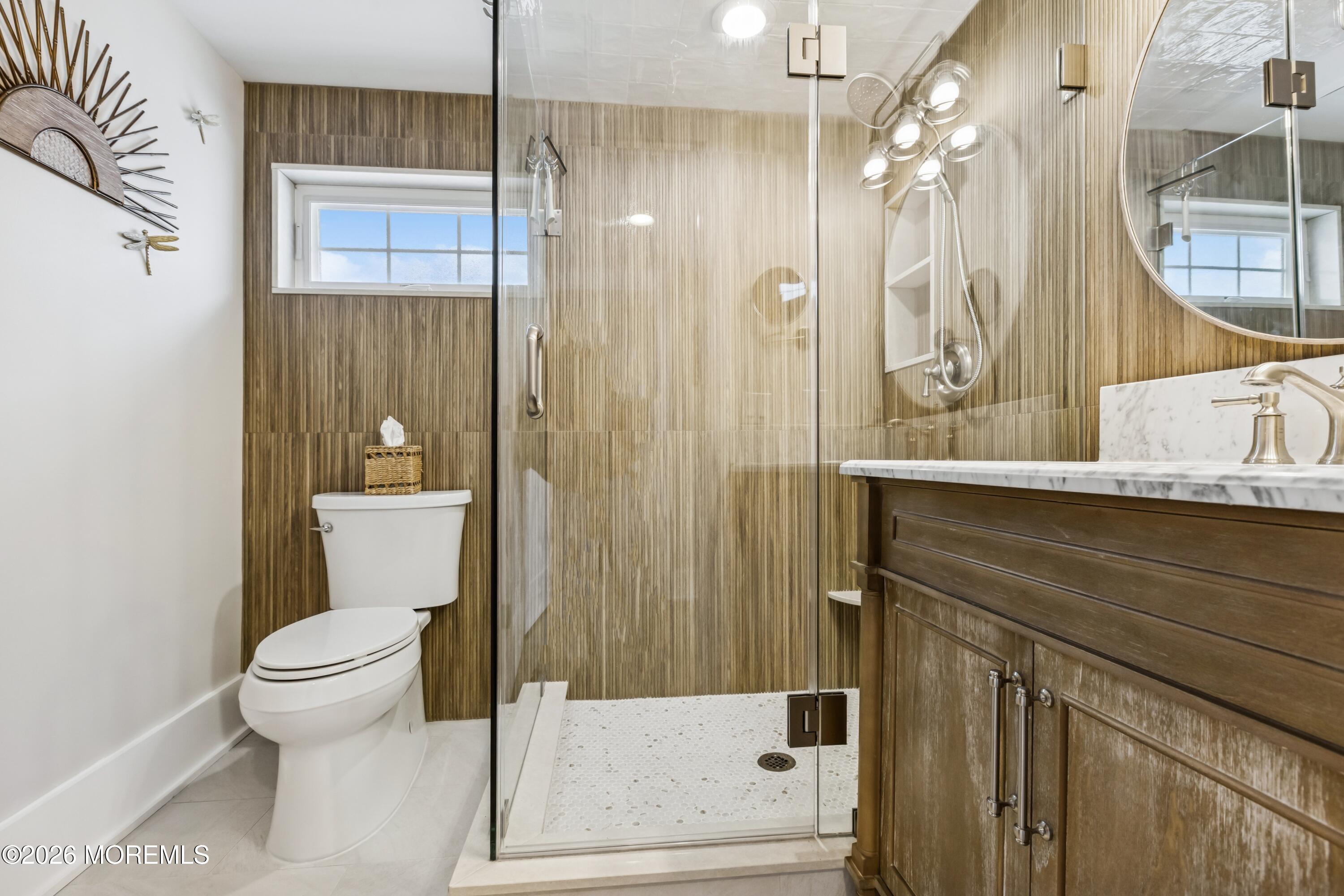 124 2nd Avenue Manasquan, NJ 08736 - Photo 19 of 38 a bathroom with a sink a toilet a mirror and shower
