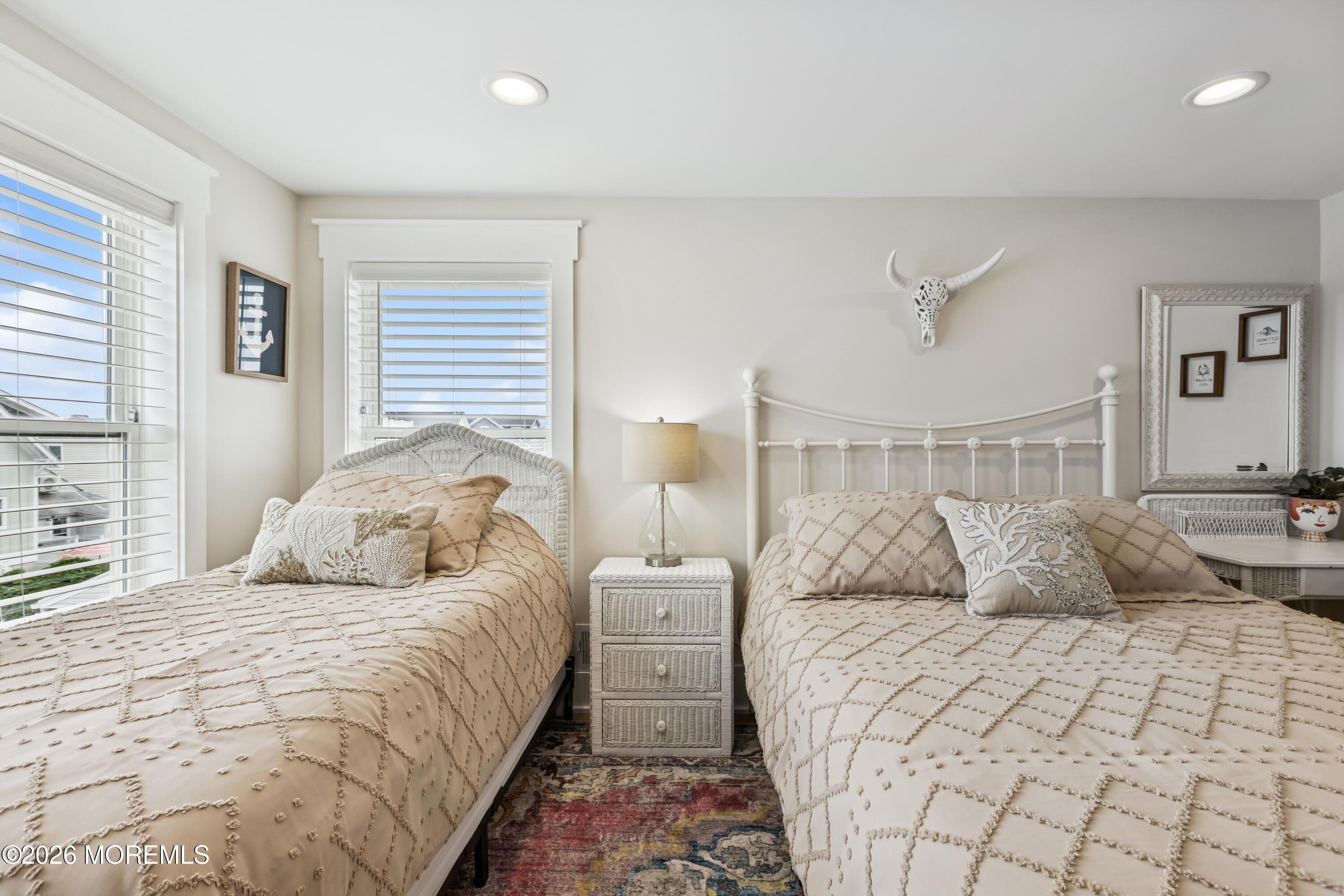 124 2nd Avenue Manasquan, NJ 08736 - Photo 22 of 38 a bedroom with a large bed and a lamp