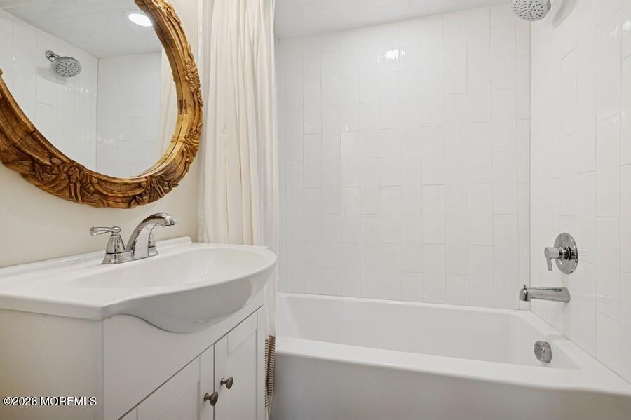 124 2nd Avenue Manasquan, NJ 08736 - Photo 25 of 38 a bathroom with a sink and a mirror