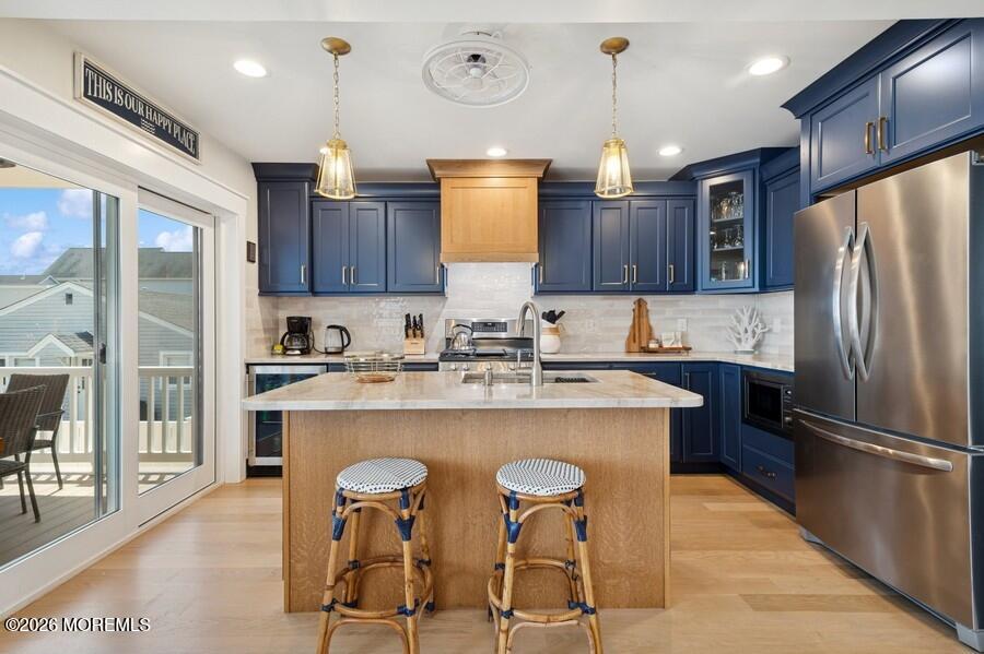 124 2nd Avenue Manasquan, NJ 08736 - Photo 6 of 38 a kitchen with stainless steel appliances granite countertop a sink refrigerator and cabinets