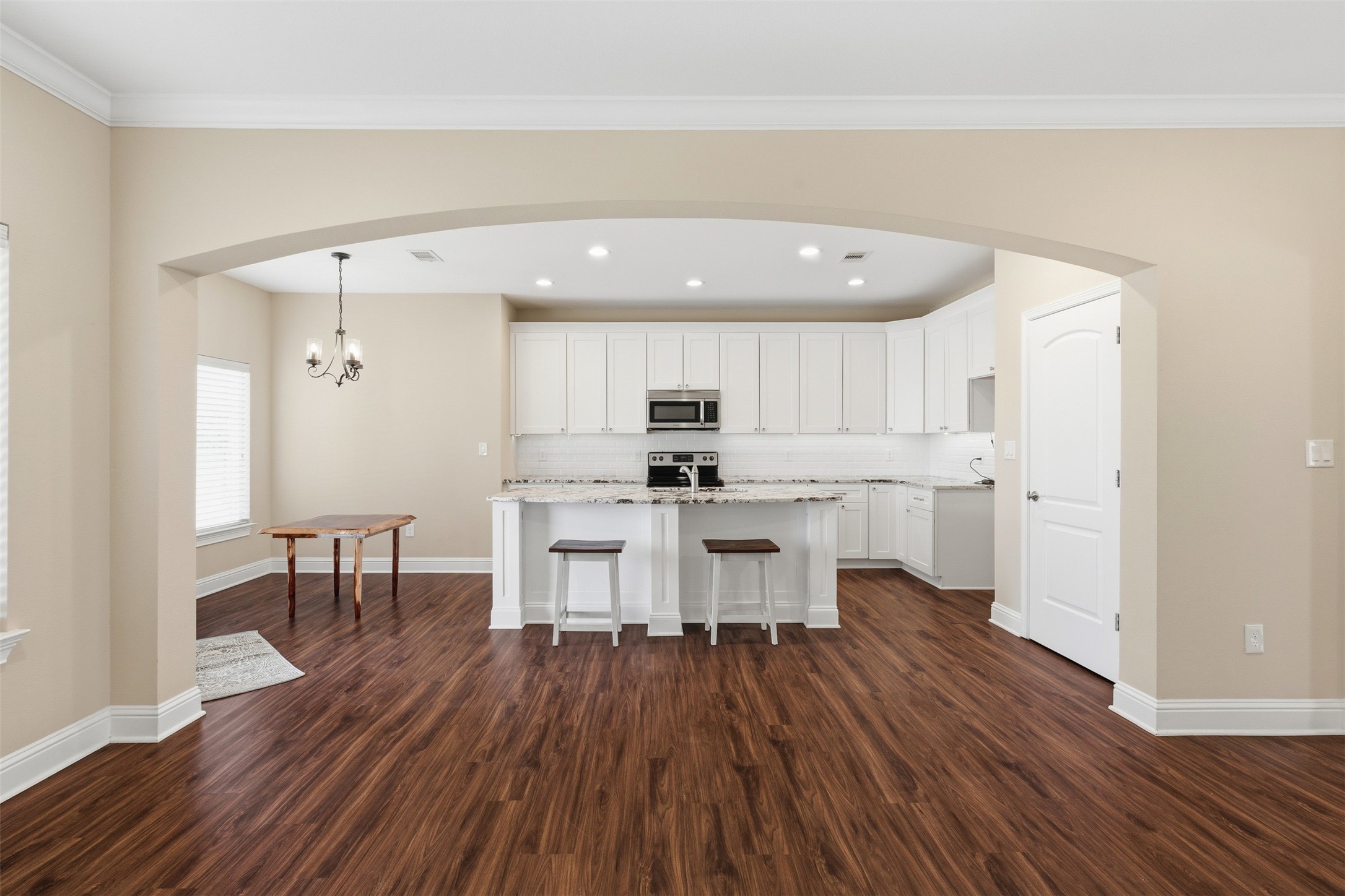 31602 Cypress Circle Waller, TX 77484 - Photo 11 of 32 a open kitchen with a sink dishwasher a dining table and chairs with wooden floor