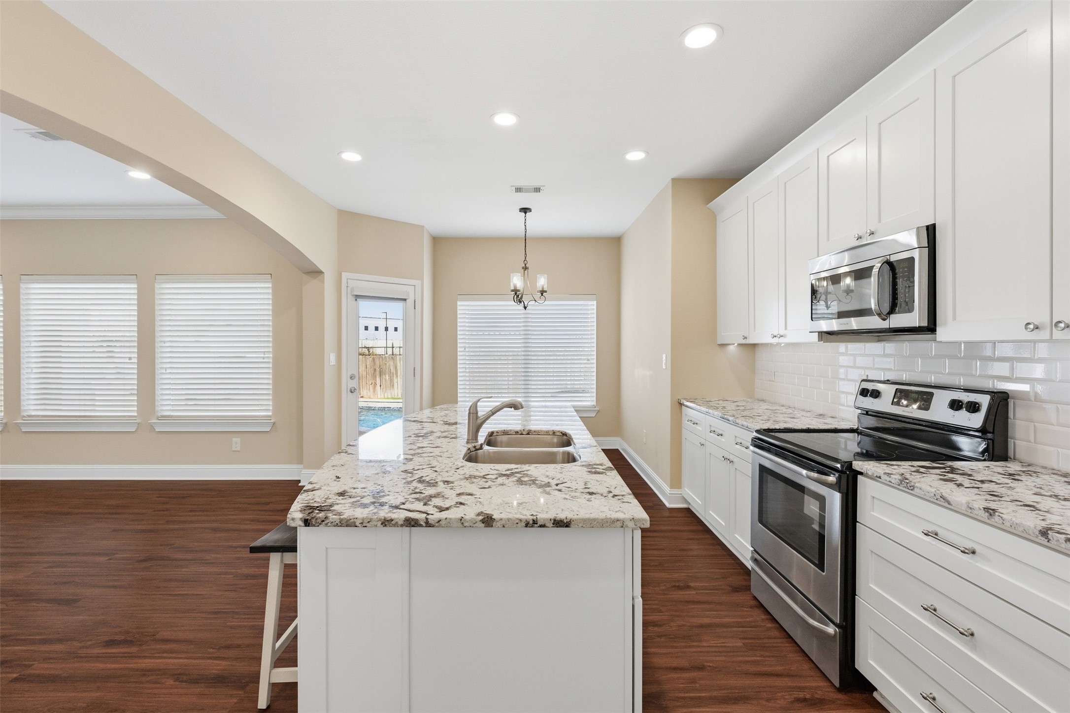 31602 Cypress Circle Waller, TX 77484 - Photo 12 of 32 a kitchen with stainless steel appliances granite countertop a stove a sink and a refrigerator