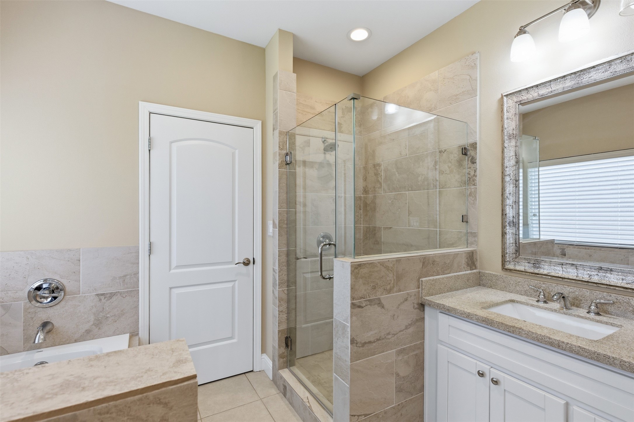 31602 Cypress Circle Waller, TX 77484 - Photo 16 of 32 a bathroom with a granite countertop sink a mirror and a shower