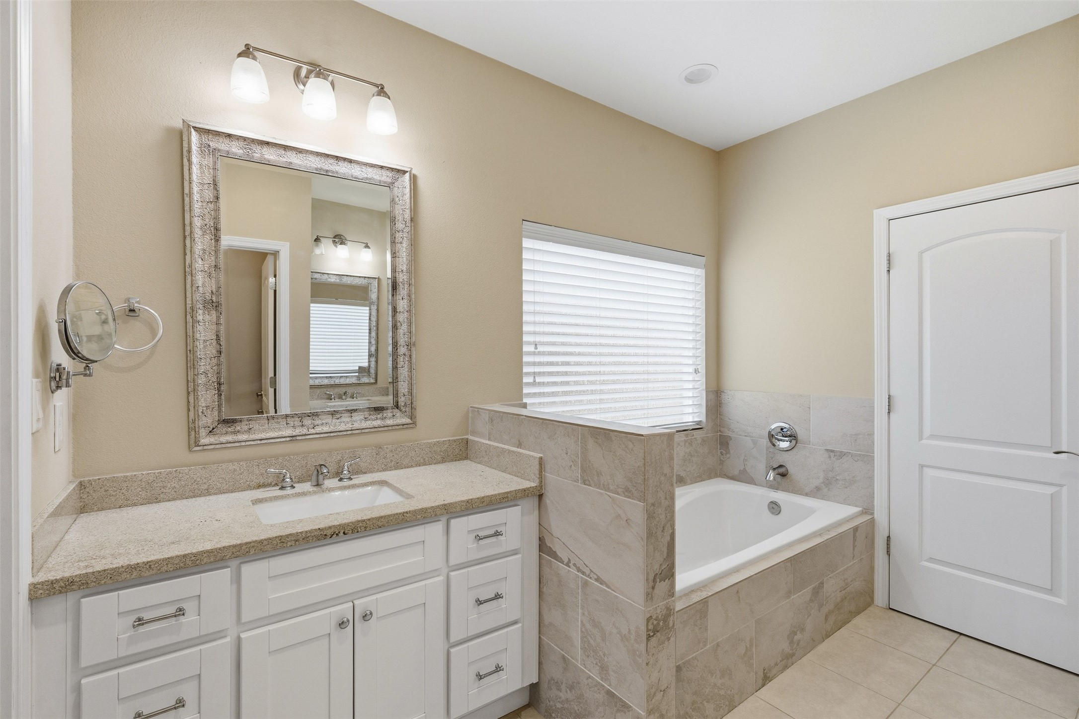 31602 Cypress Circle Waller, TX 77484 - Photo 18 of 32 a bathroom with a tub a sink and mirror