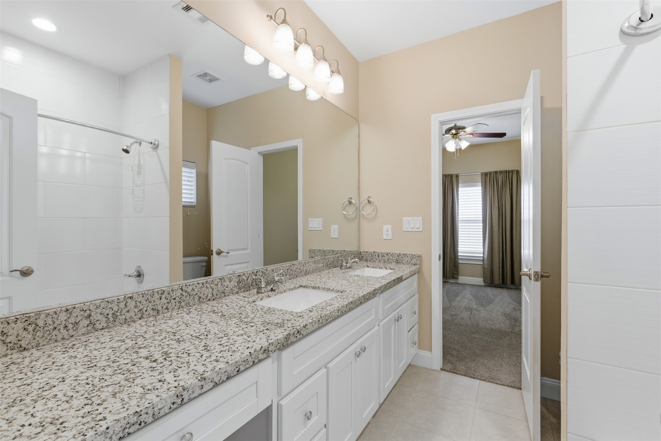 31602 Cypress Circle Waller, TX 77484 - Photo 22 of 32 a bathroom with a granite countertop double vanity sink and a mirror