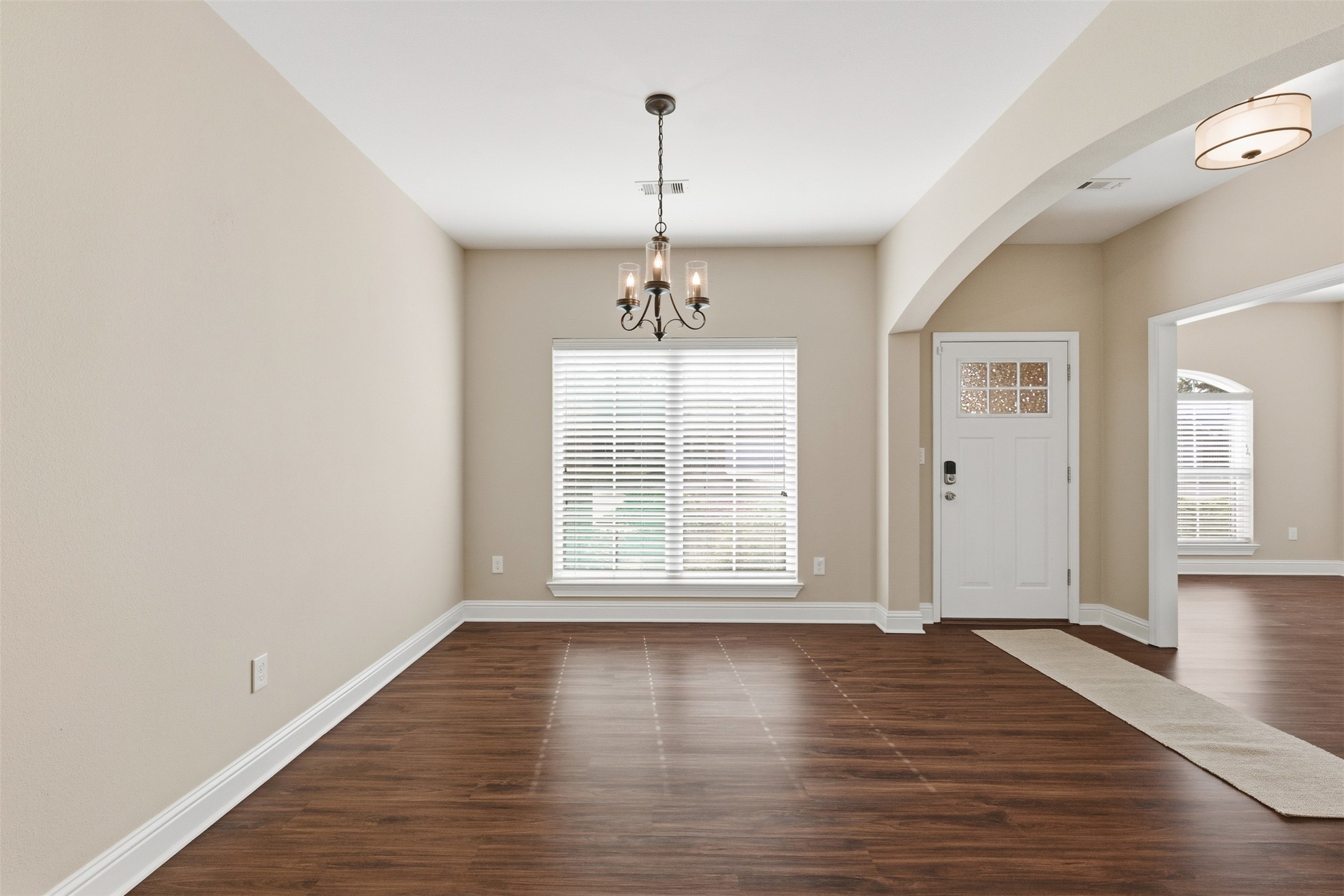 31602 Cypress Circle Waller, TX 77484 - Photo 5 of 32 an empty room with wooden floor chandelier and windows