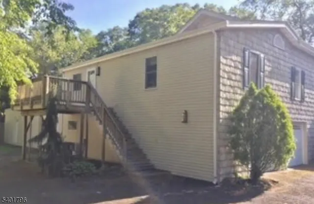 a view of a house with a tree