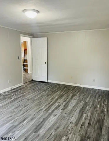 a view of an empty room and wooden floor