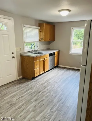 an empty room with wooden floor and window
