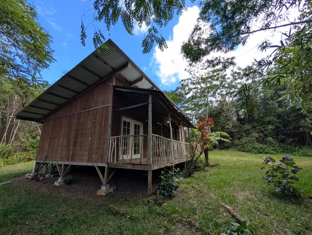 a wooden house with a small yard and wooden fence