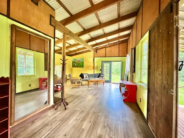 a view of living room with furniture and wooden floor