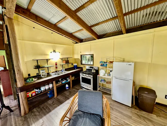a kitchen with stainless steel appliances granite countertop a sink and wooden cabinets