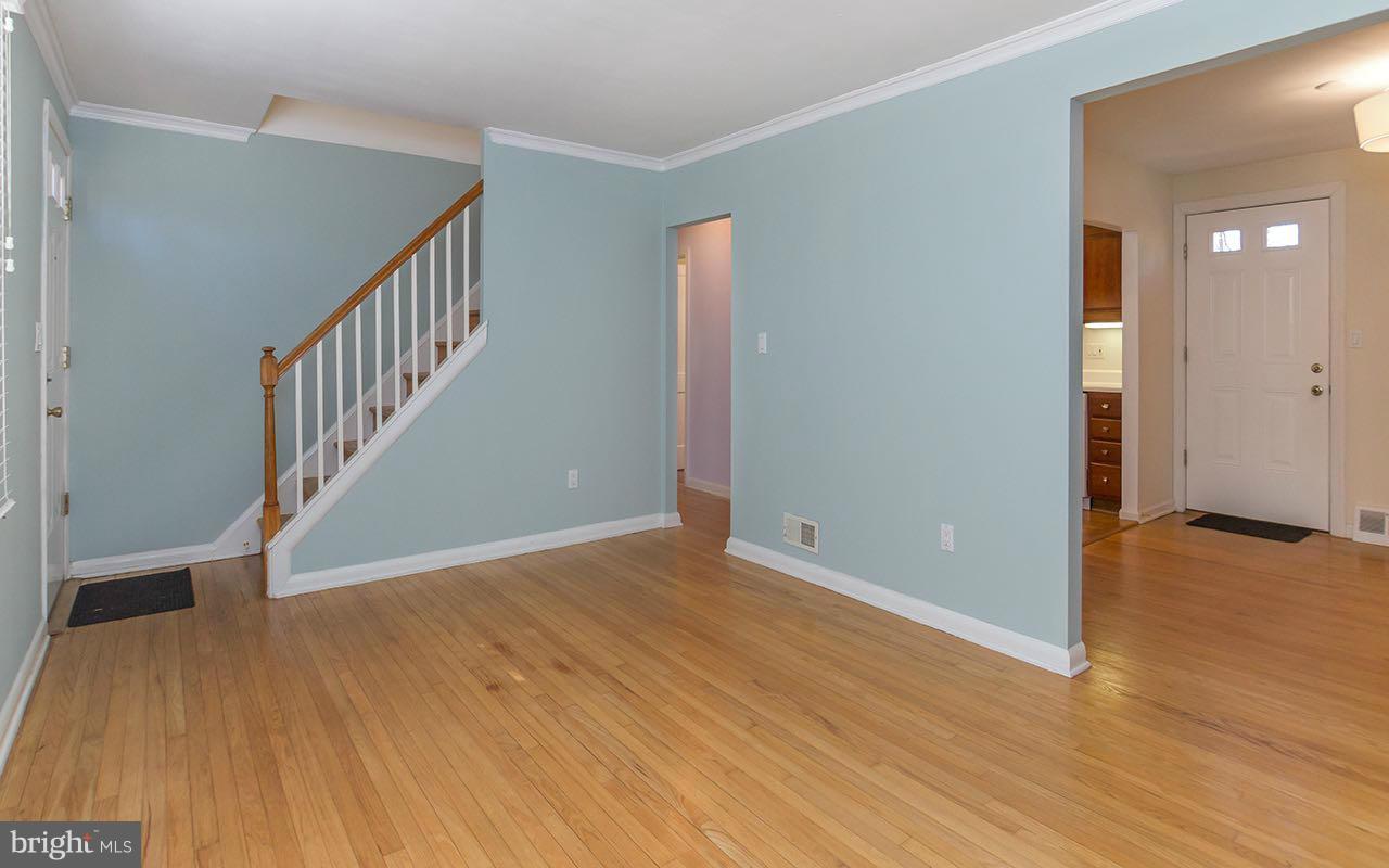 708 Sudbrook Road Pikesville, MD 21208 - Photo 2 of 30 a view of an empty room with wooden floor and entryway