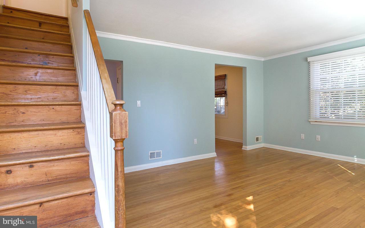 708 Sudbrook Road Pikesville, MD 21208 - Photo 13 of 30 a view of entryway with wooden floor and stairs