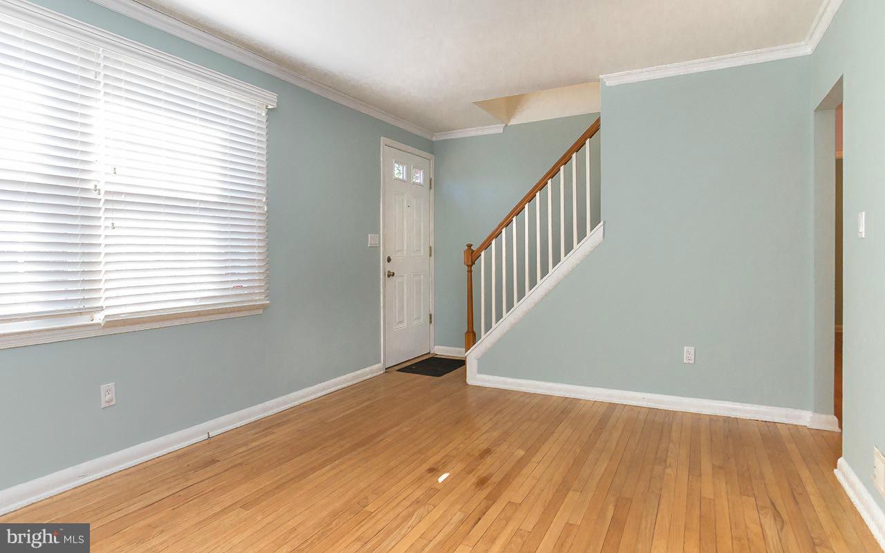 708 Sudbrook Road Pikesville, MD 21208 - Photo 14 of 30 a view of an empty room with wooden floor and a window