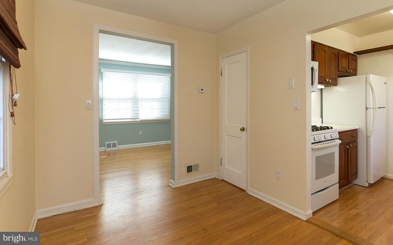 708 Sudbrook Road Pikesville, MD 21208 - Photo 16 of 30 a view of a kitchen with wooden floor and electronic appliances
