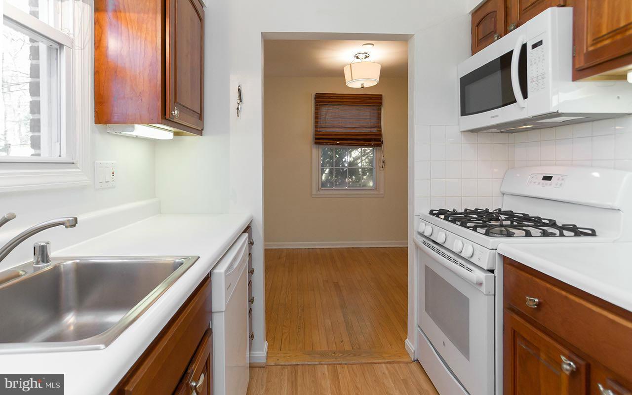 708 Sudbrook Road Pikesville, MD 21208 - Photo 19 of 30 a kitchen with stainless steel appliances a stove a microwave and a sink