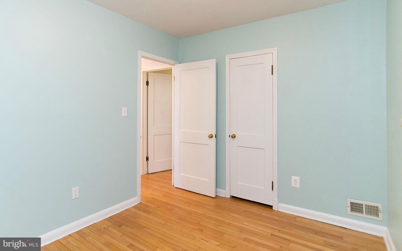 708 Sudbrook Road Pikesville, MD 21208 - Photo 20 of 30 a view of an empty room with wooden floor