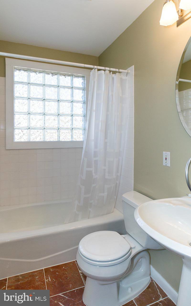 708 Sudbrook Road Pikesville, MD 21208 - Photo 21 of 30 a bathroom with a toilet a sink and a bathtub