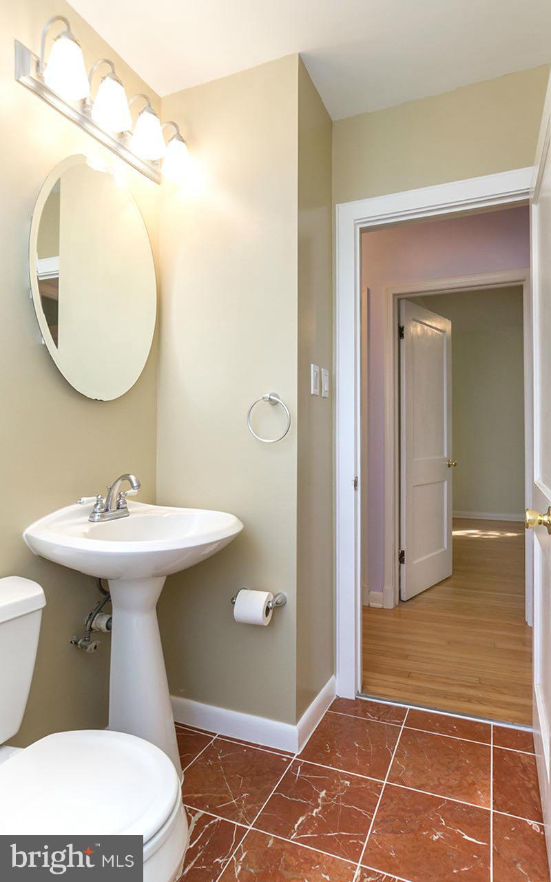 708 Sudbrook Road Pikesville, MD 21208 - Photo 22 of 30 a bathroom with a sink toilet and mirror