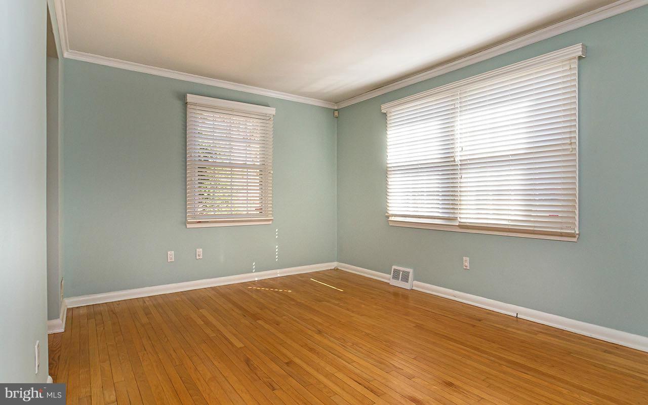 708 Sudbrook Road Pikesville, MD 21208 - Photo 23 of 30 a view of a room with wooden floor and windows