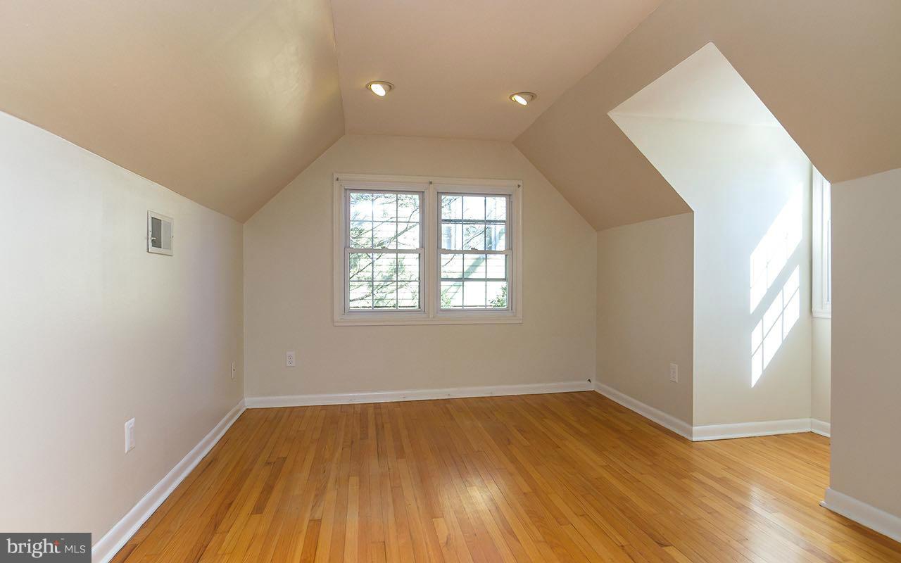 708 Sudbrook Road Pikesville, MD 21208 - Photo 24 of 30 an empty room with wooden floor and windows