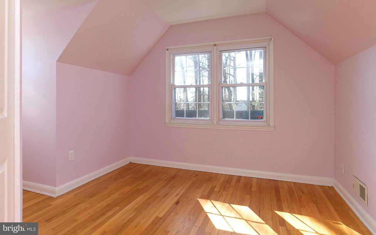 708 Sudbrook Road Pikesville, MD 21208 - Photo 26 of 30 an empty room with wooden floor and windows