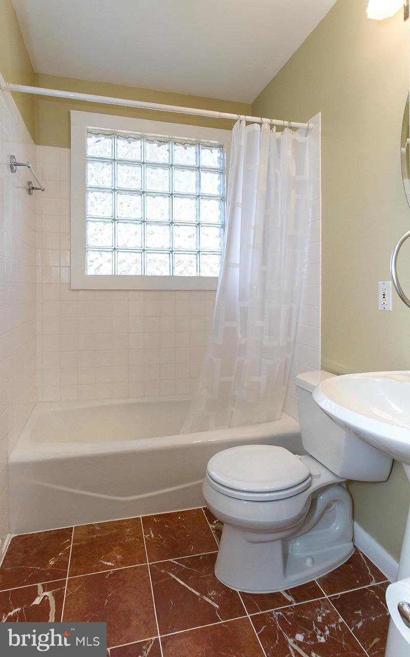 708 Sudbrook Road Pikesville, MD 21208 - Photo 5 of 30 a bathroom with a toilet and a shower