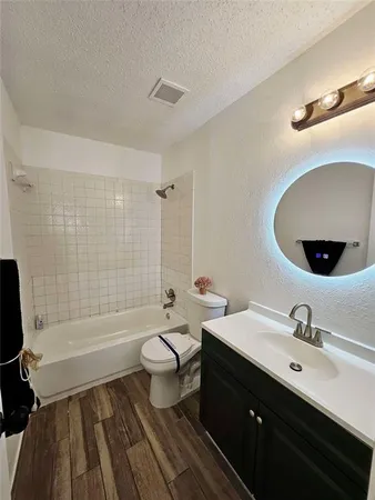 a bathroom with a double vanity sink toilet mirror and bathtub