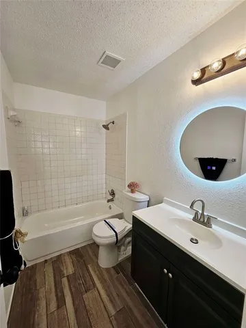 a bathroom with a double vanity sink toilet mirror and bathtub