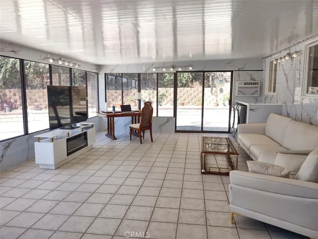 a living room with furniture and large windows