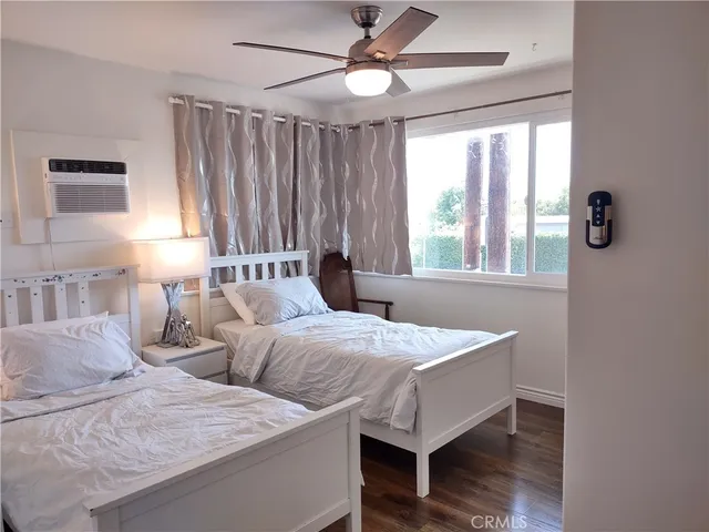 a bedroom with two beds and a window