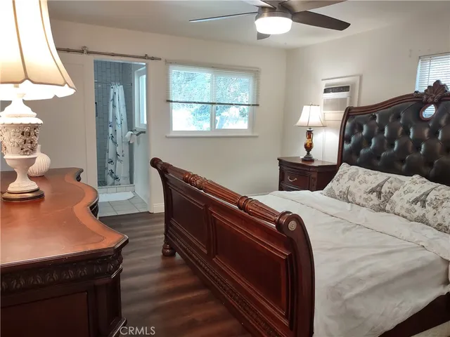 a bedroom with bed and window