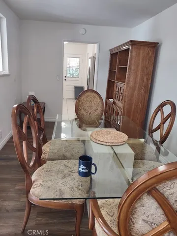 a living room with dining table and chairs