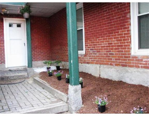 35 Cedar Street, Unit 2 Gardner, MA 01440 - Photo 2 of 9 a view of a brick house with outdoor space